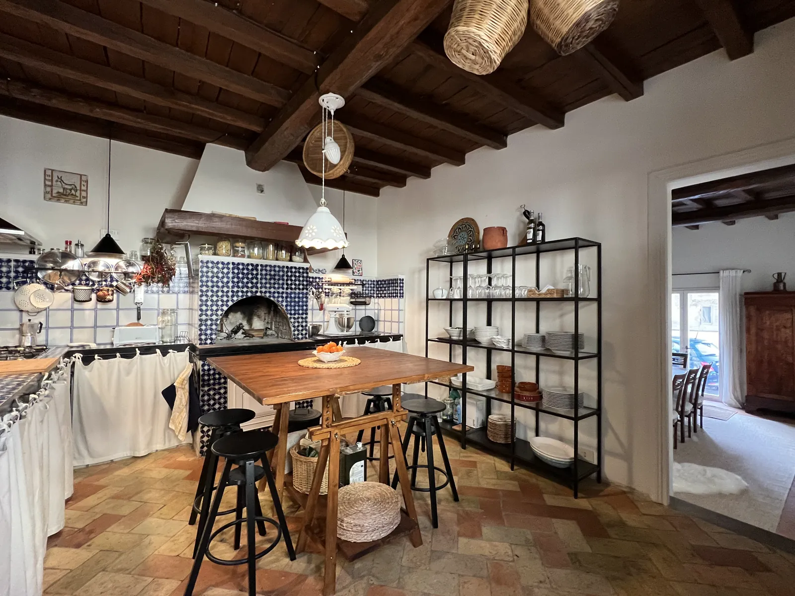 Kitchen with terracotta floor and open shelving