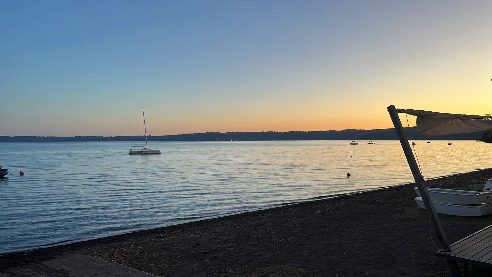 Sailboat on Lake Bracciano at sunset
